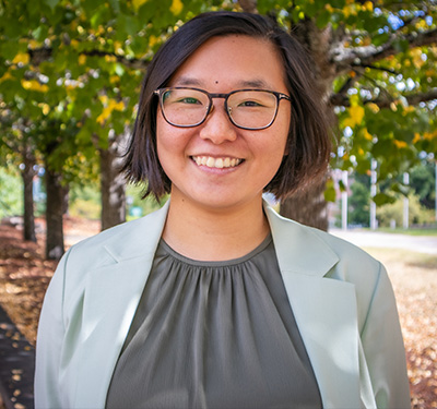 Picture of Dr. Doris Chow, St. Thomas University Psychology Professor, standing in the university's courtyard.
