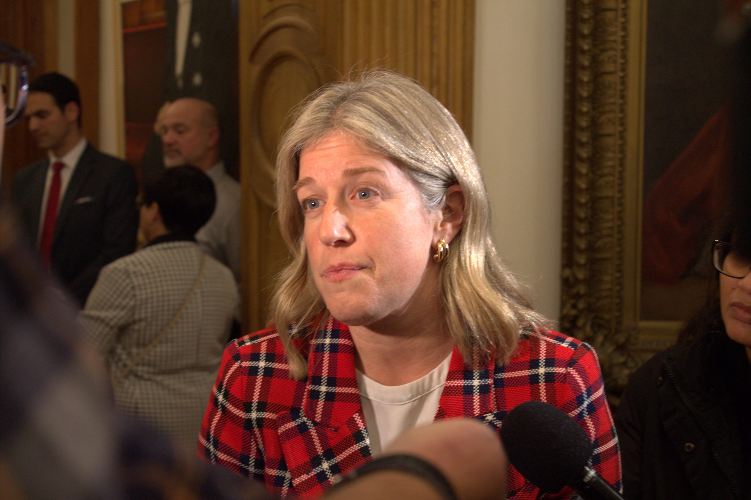 Susan Holt takes questions from reporters.