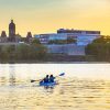 Two people paddle a kayak on Fredericton's Wolastoq River.