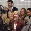 Susan Holt speaks at a podium surrounded by cameras and her cabinet ministers.