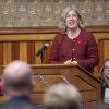 New Brunswick Premier Susan Holt at a podium addressing the New Brunswick legislature.